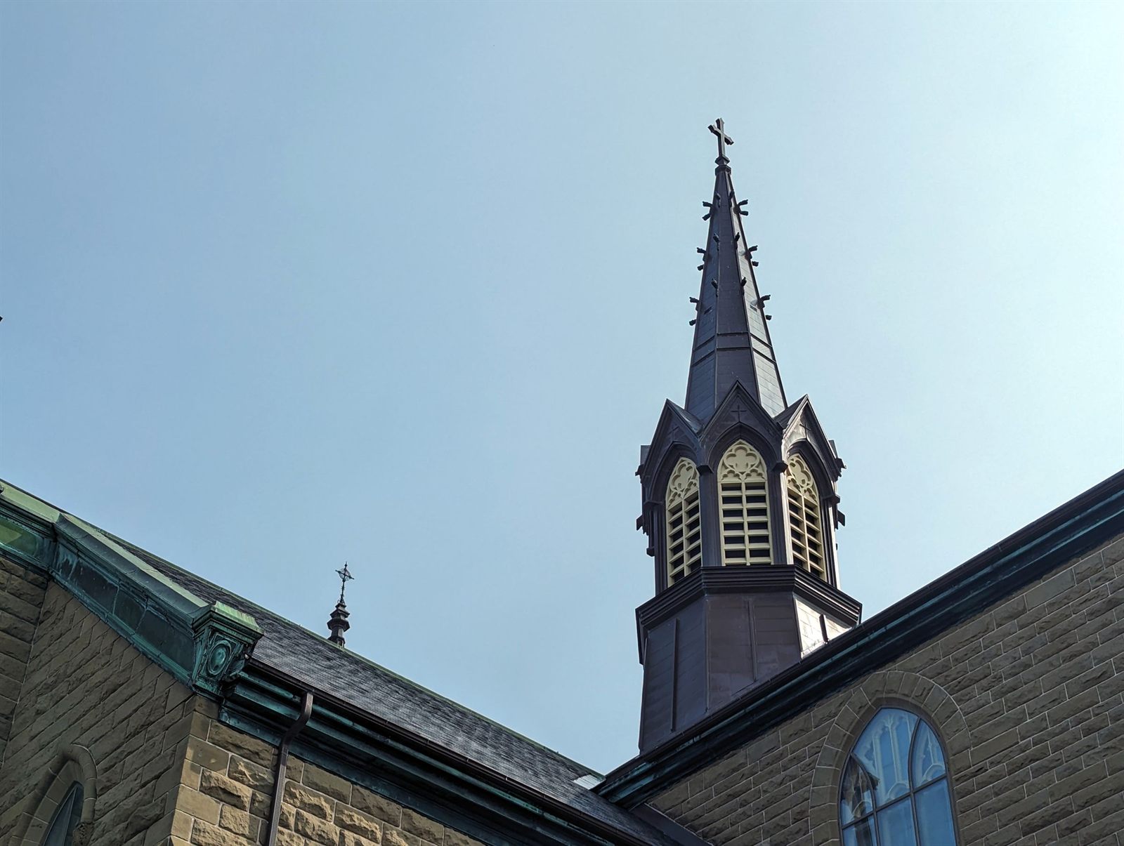 Gothic stone church spire against a pale sky in Charlottetown
